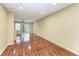Spacious living room with hardwood floors and a sliding glass door that allows plenty of natural light at 8943 White Sage Loop, Lakewood Ranch, FL 34202