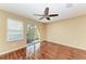 Bright living room with laminate flooring, access to a balcony, and a ceiling fan at 8943 White Sage Loop, Lakewood Ranch, FL 34202