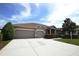 Beautiful single-story home featuring a well-maintained lawn and a spacious three-car garage with lots of parking at 9112 63Rd E Ct, Parrish, FL 34219