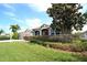 Charming single-story house with manicured lawn, vibrant shrubbery, and an elegant entryway at 9112 63Rd E Ct, Parrish, FL 34219