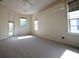 Spacious main bedroom with neutral carpet and tray ceiling detail, plus bright natural light from multiple windows at 9112 63Rd E Ct, Parrish, FL 34219