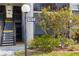 Exterior view of property featuring well-kept landscaping and stairs leading to unit at 3269 Beneva Rd # 102, Sarasota, FL 34232