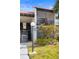 Exterior of a multi-story home with a tile roof, beautiful landscaping and a light post at 3269 Beneva Rd # 102, Sarasota, FL 34232