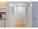 Hallway with access to kitchen, bathrooms and bedrooms. Neutral paint and tile flooring at 3269 Beneva Rd # 102, Sarasota, FL 34232