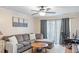 Comfortable living room space featuring a large window with curtains and a workstation at 3269 Beneva Rd # 102, Sarasota, FL 34232