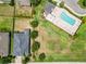 Aerial view of a community pool with lounge chairs and landscaping, with adjacent parking at 10860 79Th E St, Parrish, FL 34219