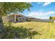 Lush backyard featuring green lawn, a covered patio, and plenty of space for outdoor activities and relaxation at 10860 79Th E St, Parrish, FL 34219
