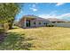 Spacious backyard with lush green lawn and a covered patio perfect for outdoor entertaining and relaxation at 10860 79Th E St, Parrish, FL 34219
