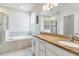 The bathroom features double sinks, granite countertops, a soaking tub, and a walk-in shower at 10860 79Th E St, Parrish, FL 34219