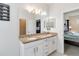 A spacious bathroom with double sinks, white cabinets, granite countertops, and decor at 10860 79Th E St, Parrish, FL 34219