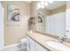 Bathroom featuring a vanity with granite countertop, white cabinetry, and decorative art at 10860 79Th E St, Parrish, FL 34219