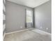 Neutral bedroom with soft carpet, window, and a striped accent wall at 10860 79Th E St, Parrish, FL 34219