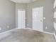 Neutral bedroom with soft carpet, two closets, and a striped accent wall at 10860 79Th E St, Parrish, FL 34219
