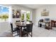 Bright dining area features a marble table, a sliding glass door, and modern artwork at 10860 79Th E St, Parrish, FL 34219