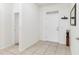 Bright foyer with tiled flooring, white walls, and coat rack at 10860 79Th E St, Parrish, FL 34219