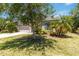 Beautiful home with mature trees, manicured lawn, and attractive landscaping at 10860 79Th E St, Parrish, FL 34219