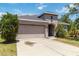Beautiful home with well-manicured front yard and an attached two-car garage at 10860 79Th E St, Parrish, FL 34219
