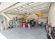 Spacious two-car garage with epoxy floor, overhead storage racks, and ample room for storage and projects at 10860 79Th E St, Parrish, FL 34219