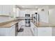 Bright kitchen with white cabinets, stainless steel appliances, granite countertops, and tile flooring at 10860 79Th E St, Parrish, FL 34219