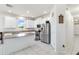 Spacious kitchen offers white cabinets, stainless appliances, granite counters and a large island at 10860 79Th E St, Parrish, FL 34219