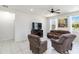 Comfortable living room showcasing tile floors, neutral walls, and a cozy seating arrangement at 10860 79Th E St, Parrish, FL 34219