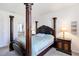 Traditional main bedroom featuring a four-poster bed and dark wood furnishings at 10860 79Th E St, Parrish, FL 34219