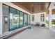 Spacious balcony with glass sliding doors, wood plank ceiling, and views of the tropical landscape at 114 Fillmore Dr, Sarasota, FL 34236