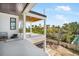 Open balcony features white columns and overlooks lush tropical landscaping with neighborhood views at 114 Fillmore Dr, Sarasota, FL 34236