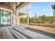 Covered balcony with views of backyard and tropical surroundings through white columns at 114 Fillmore Dr, Sarasota, FL 34236