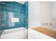 Bathroom featuring new blue accent tiles in shower and white vanity needing fixtures installed at 114 Fillmore Dr, Sarasota, FL 34236