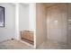 Modern bathroom with wood vanity, tiled shower, and a window, combining style and functionality at 114 Fillmore Dr, Sarasota, FL 34236