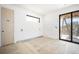Bedroom view shows bright white walls, flooring, and new sliding glass doors to a balcony at 114 Fillmore Dr, Sarasota, FL 34236