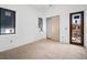 Bedroom featuring a wooden floor, modern black windows, and door to the outside at 114 Fillmore Dr, Sarasota, FL 34236