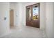 Spacious entryway with elegant double doors, freshly painted walls, and a glimpse of the home's exterior at 114 Fillmore Dr, Sarasota, FL 34236