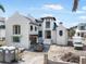Detailed view of a two-story home's exterior, highlighting its architecture and surrounding landscape under construction at 114 Fillmore Dr, Sarasota, FL 34236