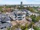 Aerial view capturing the architectural details of a modern home, with landscaping and scenic surroundings at 114 Fillmore Dr, Sarasota, FL 34236