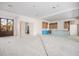 Sunlit living area with unfinished kitchen cabinets, large windows, and a seamless flow to other spaces at 114 Fillmore Dr, Sarasota, FL 34236