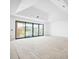 Bright living room boasts a tray ceiling and large sliding glass doors, offering scenic outdoor views at 114 Fillmore Dr, Sarasota, FL 34236