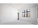 Bright room featuring a large window, white walls, and a smooth concrete floor at 114 Fillmore Dr, Sarasota, FL 34236