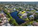 Stunning aerial view of lakeside home in established neighborhood with mature trees and water view at 1310 91St Nw Ct, Bradenton, FL 34209