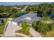 An aerial view of a sprawling blue home, showcasing a waterfront location and beautifully landscaped yard at 1310 91St Nw Ct, Bradenton, FL 34209