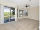 Bedroom with a bay window providing views of the lake and a sliding glass door to balcony at 1310 91St Nw Ct, Bradenton, FL 34209