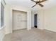 Neutral bedroom with carpet, a ceiling fan, and a closet with shelves and hanging racks at 1310 91St Nw Ct, Bradenton, FL 34209