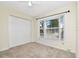 Cozy bedroom with carpet, large window, and a closet offering ample storage space in a home at 1310 91St Nw Ct, Bradenton, FL 34209