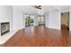 Bright living room featuring tile floors, a cozy fireplace, a ceiling fan, and sliding glass doors to the outside at 1310 91St Nw Ct, Bradenton, FL 34209