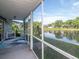 A screened in porch with an outdoor rug and view of the scenic waterfront at 1310 91St Nw Ct, Bradenton, FL 34209