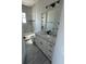 Bathroom with a large mirror, white vanity, gray countertops, modern fixtures, and tiled shower/tub at 14343 Myakka Ave, Port Charlotte, FL 33953