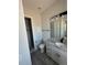 Bright bathroom featuring a white vanity, gray countertops, mirror, and tiled walk-in shower at 14343 Myakka Ave, Port Charlotte, FL 33953