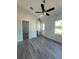 Bedroom highlighting gray floors, a ceiling fan, closet, and natural light from the window at 14343 Myakka Ave, Port Charlotte, FL 33953
