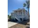 Charming two-story home with elevated porch, white railings, and new landscaping at 14343 Myakka Ave, Port Charlotte, FL 33953